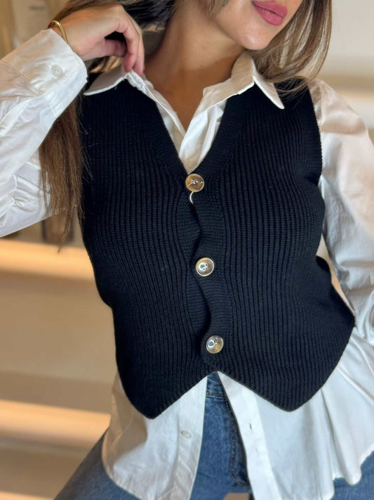 Women’s black knit button-front vest layered over a white shirt