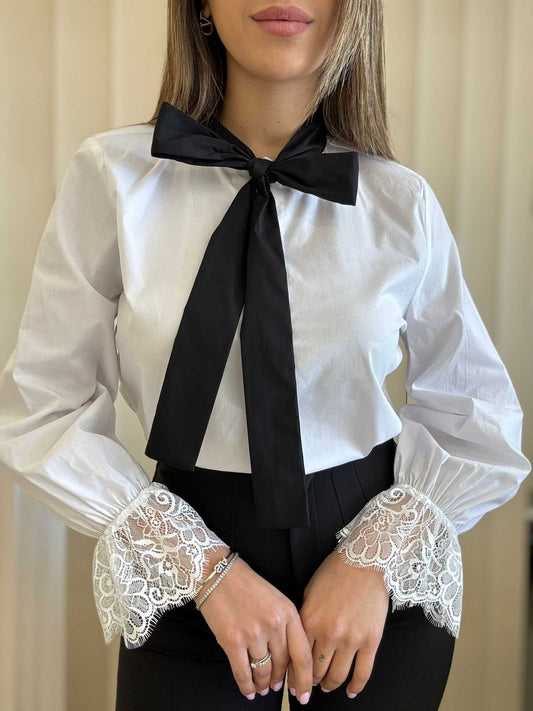 White Blouse With Black Bow And Lace Cuffs