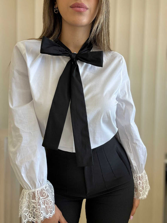White Blouse With Black Bow And Lace Cuffs